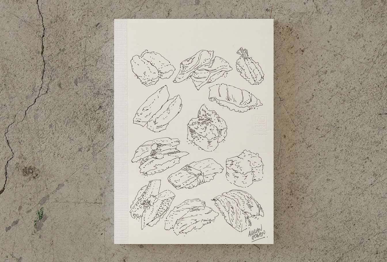 MD Notebook 15th – Edition Adrian Hogan - A6 - blanko / blank - Midori Notizbuch - limitiert MD Notebook 15th – Edition Adrian Hogan - A6 - blanko / blank - Midori Notizbuch - limitiert